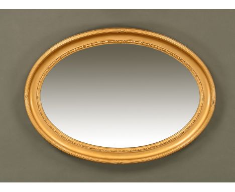 An early 20th century bevelled glass oval mirror with gilt frame.  66 cm x 90 cm.