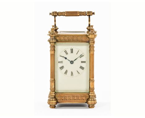 An Edwardian brass carriage clock, timepiece only with column corners and raised on short bun feet.  Height 12 cm. CONDITION 