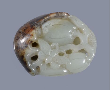 A Chinese white and russet jade 'melon and butterfly' pendant, with the russet and brown skin forming part of the carving of 