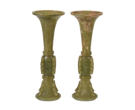A pair of Chinese celadon and russet jade archaistic vases, gu, 19th or early 20th century, of slender form with carved proje