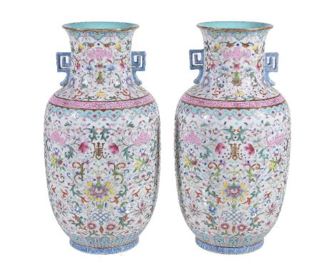 A pair of Chinese Famille Rose two-handled vases, enamelled in shades of rose-pink, blue, green, yellow and red and reserved 