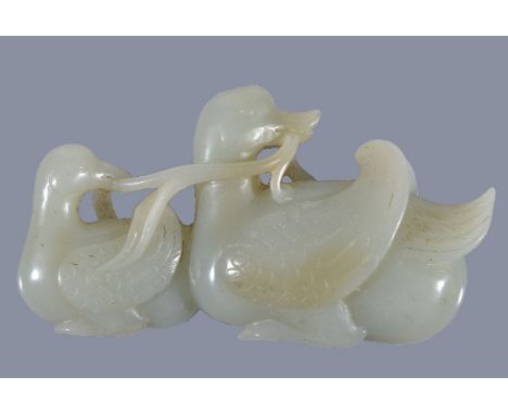 A Chinese celadon jade carving of two Mandarin ducks, Qing Dynasty, 19th century, the feathers finely detailed, 8cm long x 4.