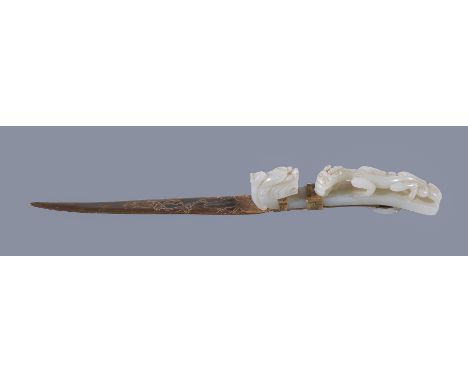 A Chinese white jade belt hook, Qing Dynasty, the archaistic belt hook carved from a white translucent stone in the form of a