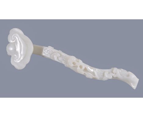 A white jade 'Lingzhi' ruyi sceptre, terminating in a large lingzhi head, the curved shaft worked in high relief and openwork