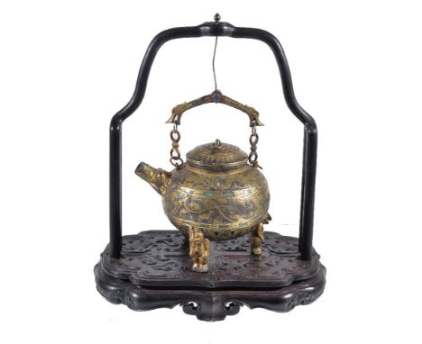 A Chinese archaic style inlaid tripod pouring vessel and cover, supported on three anthropomorphic feet, the ovoid body inlai