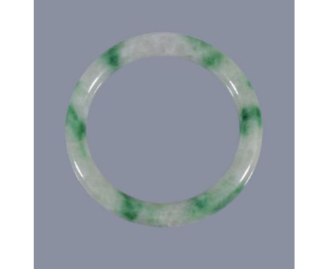 A Chinese jadeite bangle, the cylindrical jadeite band of pale green and cloudy white tone, suffused with a sections of brigh