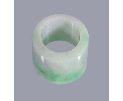 A Chinese jadeite archer's ring, probably Qing Dynasty, of cylindrical form with a bevelled edge, the stone white with splash