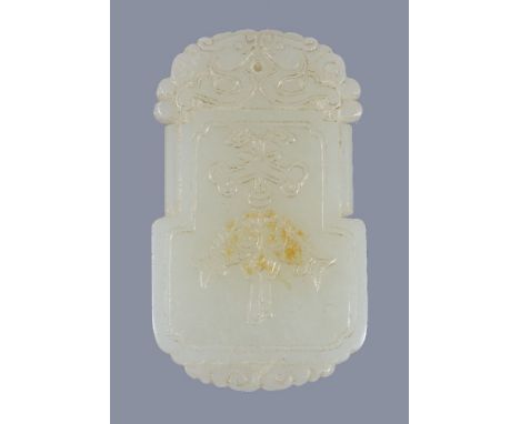 A Chinese white jade or pale celadon pendant, carved on one side with twin fish and the other side with four characters, 5.5c