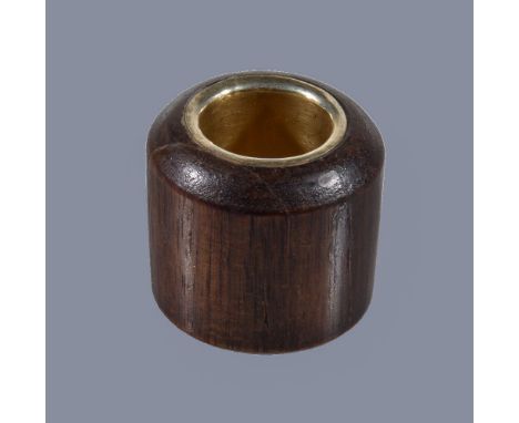 A Chinese wood gilt-metal lined Archer's ring, Qing Dynasty, the scented wood possibly Chen Xiang, 3.3cm high x 3.6cm wide, t