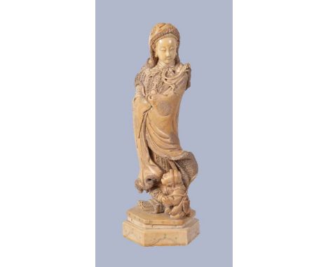 Y A large Ivory Okimono in Chinese style, depicting the figure of mulan wearing armour beneath a fur lined cloak, the figure 