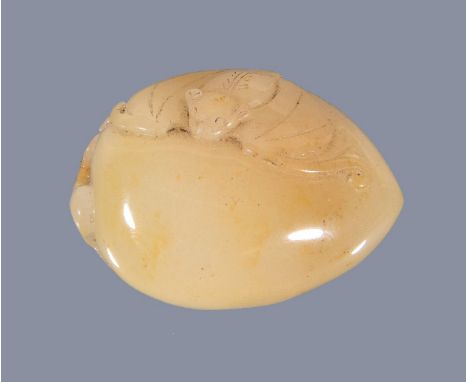 A Chinese white and brown jade ‘melon and butterfly’ carving, the three melons attached with a vine tendril on a leaf base, 1
