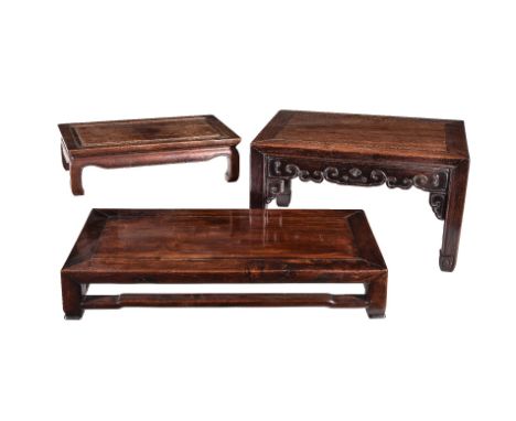 Three Chinese hardwood low tables or stands, late Qing Dynasty, 19th century, all of pegged construction, comprising: one wit
