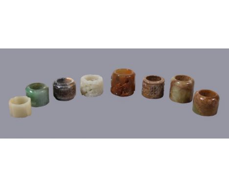 A Chinese pale celadon or white jade openwork Archer's ring, carved with facing chilong and scrolling foliage, 3.4cm diameter