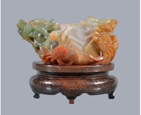 A Chinese jadeite water pot, the mottled white jade body with green and brown inclusions, on one side carved with two crabs, 