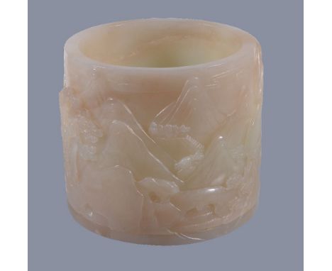 A Chinese white jade brush pot, carved with mountainous landscapes with horses and pine trees, the base with apocryphal incis