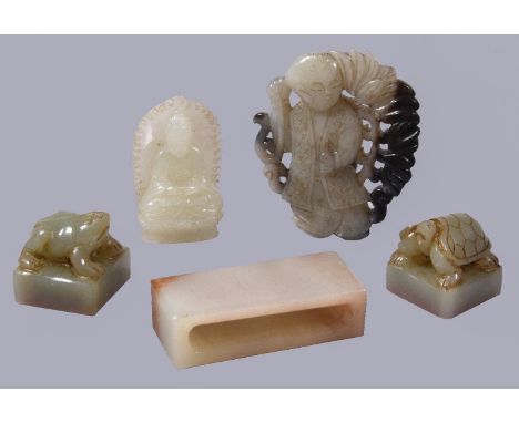 A Chinese white or pale celadon jade carving of Buddha, seated with pierced carved mandorla, 4.5cm high; a Chinese black and 