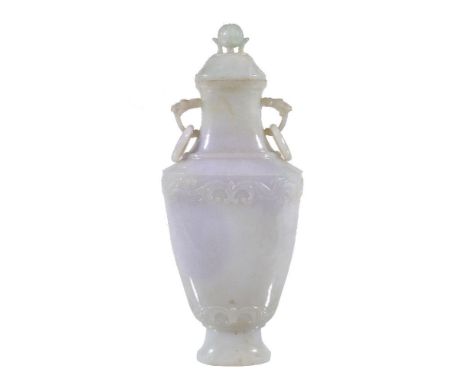 A Chinese mottled white jade vase and cover, with green and lavender inclusions, of flattened baluster form with two bands of