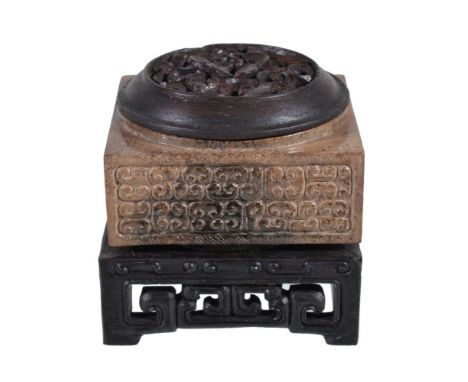 A Chinese archaistic brown and black jade cong, well carved with 'C' scrolls to each side, 5cm x 5cm, with carved wood stand 