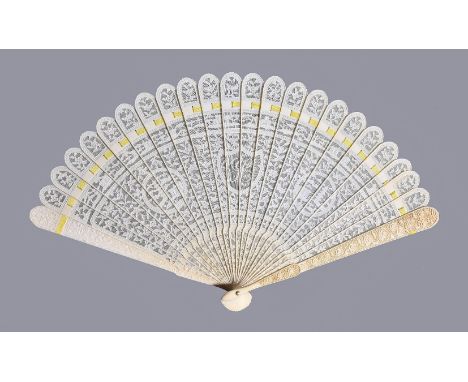 Y A Chinese ivory brise fan, Canton, first quarter of the 19th century, carved on one side, with flowers and foliage enclosin