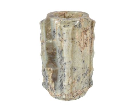 A Chinese celadon brown and black flecked jade cong, the tall rectangular body of square section, with short circular foot an