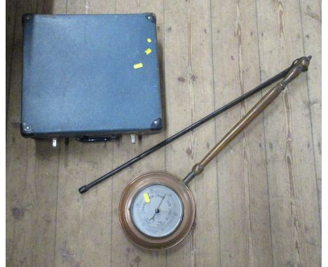 A copper warming pan, set with a barometer, a walking stick and an Air-India suitcase