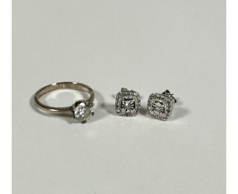 A silver paste set solitaire ring (N), a pair of silver earrings, the central diamond in illusion set setting with surround o