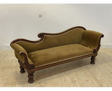 A William IV mahogany scroll arm sofa, upholstered in green velvet, raised on scroll carved turned supports H85cm, L10cm, D63