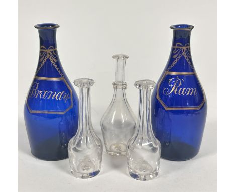 A pair of Regency bristol blue glass mallet shaped rum and brandy decanters with gilt style decorated wine labels to front, (