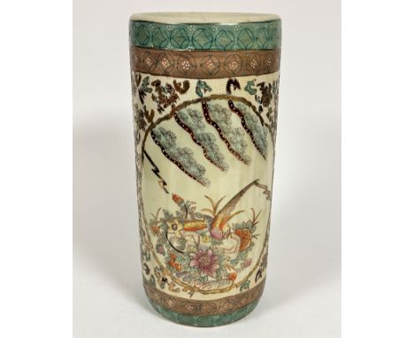 A Japanese pottery cylinder stick stand decorated with exotic birds, leaves and chrysanthemums, with buff and green banded bo