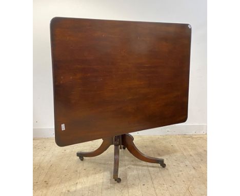 A George III mahogany tilt top breakfast table, the square top with reeded edge over ring turned column, raised on acanthus c