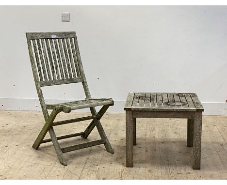 A pair of slatted silvered teak folding garden chairs (H95cm) together with a matching low table (H45cm)
