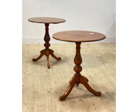 A pair of Victorian walnut and pine lamp tables, the circular tops raised on baluster columns and triple splay supports, H72c