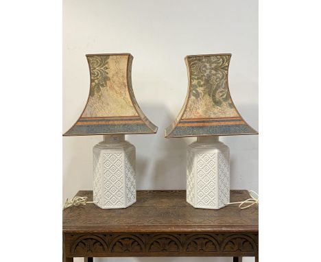 A pair of Italian white ceramic table lights of hexagonal outline with lozenge motif H68cm (Including shade)