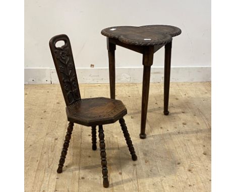 An early 20th centrury carved oak tripod table, the trefoil top raised on turned supports with pad feet, (H63cm) together wit