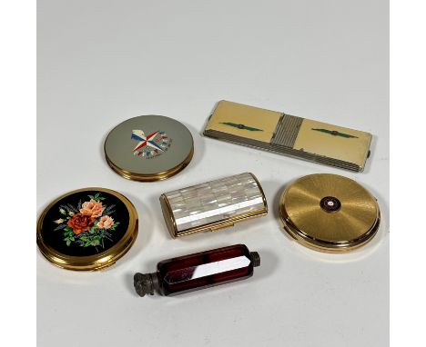 A ruby glass faceted double smelling salts bottle with chased white metal mount, one missing, a mother of pearl mounted oval 