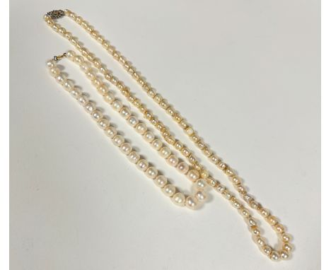 A baroque pearl necklace with white metal clasp fastening set CZ's, (L 36cm) and a modern cultured pearl necklace (L 21cm) sl