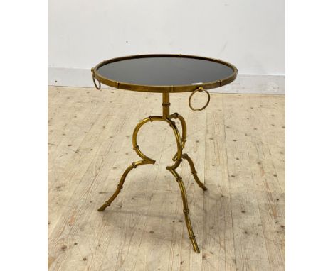 A mid century modern faux bamboo gilt aluminium lamp table, the circular black glass top raised on triple splay supports, H60