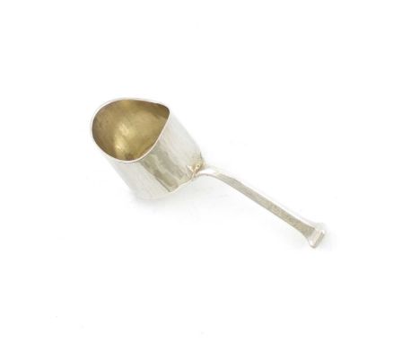 By Omar Ramsden, an Arts and Crafts silver caddy spoon, London 1931, shovel shaped bowl, tapering lozenge-shaped handle and t