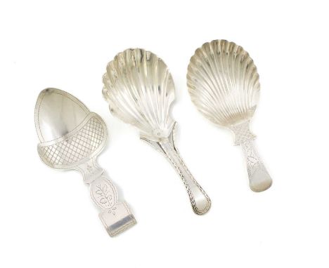 A small collection of three George III silver caddy spoons, comprising: one by Elizabeth Morley, London 1809, engraved acorn 