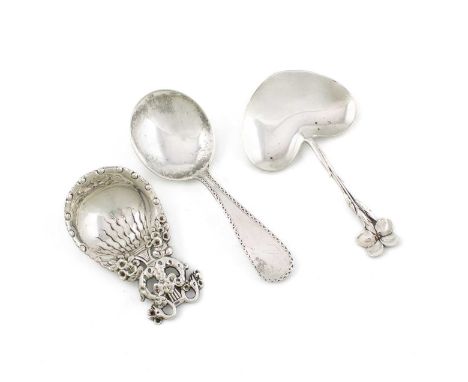 Three American silver caddy spoons, including: one by Tiffany, with a heart-shaped bowl and flower terminal, one by S. Kirk a