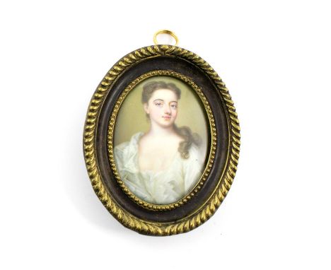 An 18th century English School enamelled portrait miniature, unsigned, the young lady in a white dress, in an oval wooden fra