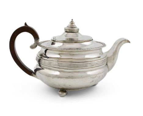 A George III silver teapot,by John Cowie, London 1814,circular form, gadroon border with reeded decoration, domed hinged cove