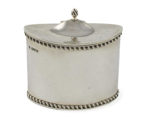 A small silver tea caddy, by Haseler Brothers, Chester 1913,oval form, gadroon border, a domed hinged cover with a flame fini