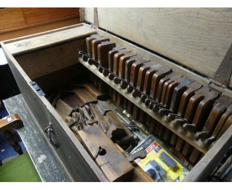 An antique pine Carpenter's Chest, fitted to hold and containing a quantity of 18th / 19thC beech Moulding Planes, various si