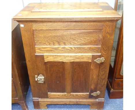 An American 20thC oak Ice Box, with hinged top enclosing lead lined ice basin, above a door and cupboard, with subtle central