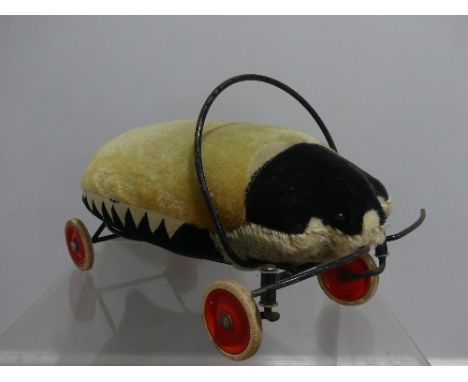 Steiff; A vintage (c.1950's) child's ride-on Ladybird, the mohair top faded, wheels marked 'Steiff 80', 20in (51cm) x 13in (3
