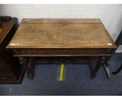 An early 20thC Continental oak Side / Console Table, with foliate carved frieze and single drawer, ribboned and fluted carved