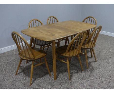 A mid 20thC Ercol light elm plank top extending Dining Table, of rounded rectangular form, with splayed tapering supports, 60