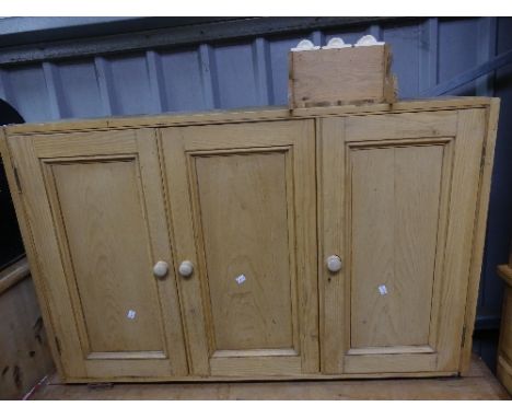 A vintage pine Cupboard, comprising one sliding door flanked by two hinged doors, enclosing shelved interior with central pla