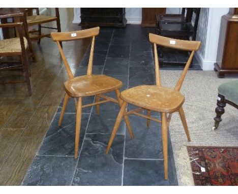 A pair of mid 20thC light elm and beech Ercol Stacking Chairs, both with holographic sticker labels, some wear, 15½in (39cm w